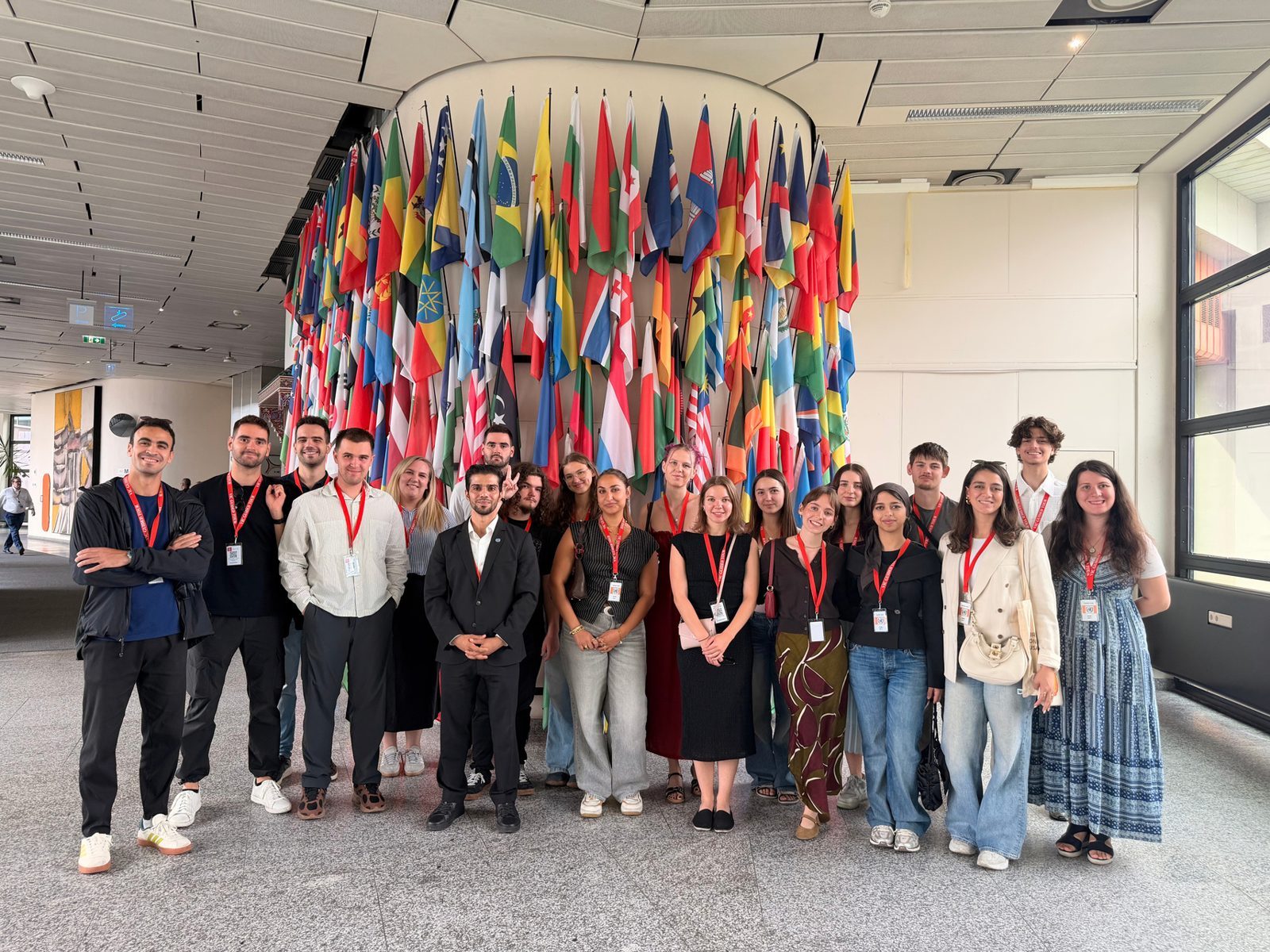Our group in front of a wall of national flags during a study visit