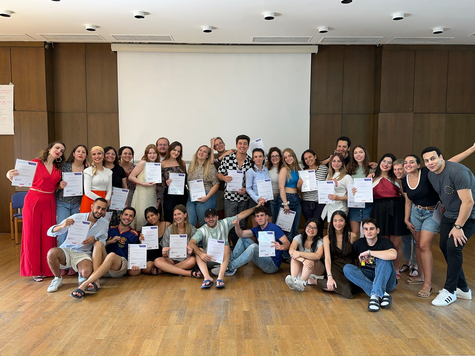 Training course participants with their certificates