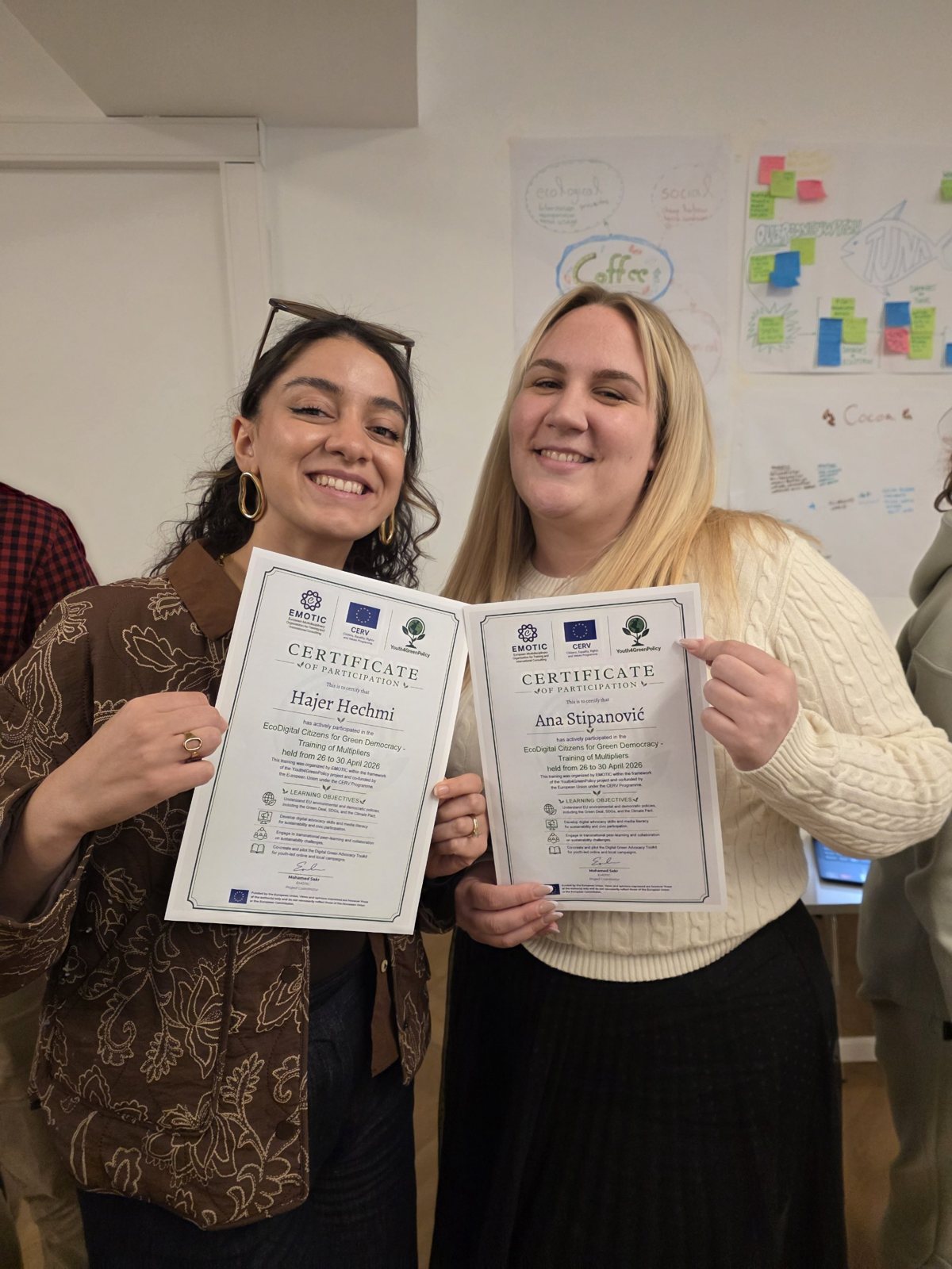 Two participants holding their certificates from the EcoDigital Citizens for Green Democracy training