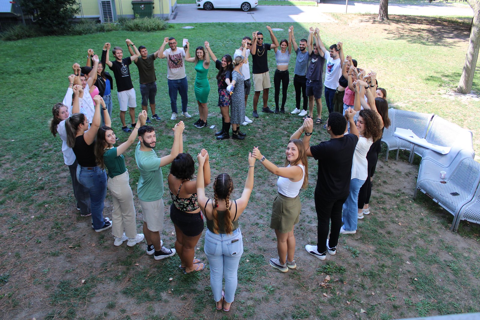 Young people sitting in a circle outdoors