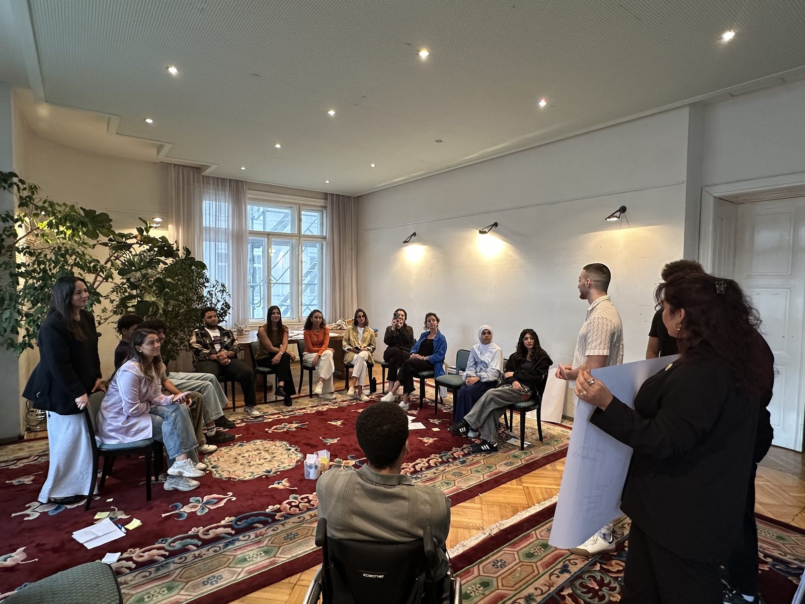 A workshop with participants seated in a circle